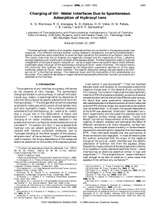 Charging of Oil-Water Interfaces Due to Spontaneous Adsorption of