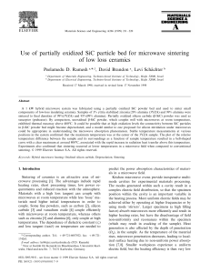 Use of partially oxidized SiC particle bed for microwave sintering of
